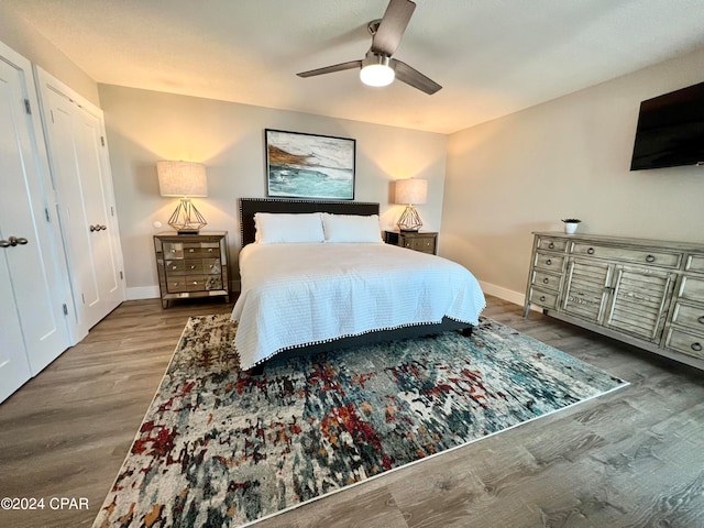 bedroom with ceiling fan and hardwood / wood-style floors