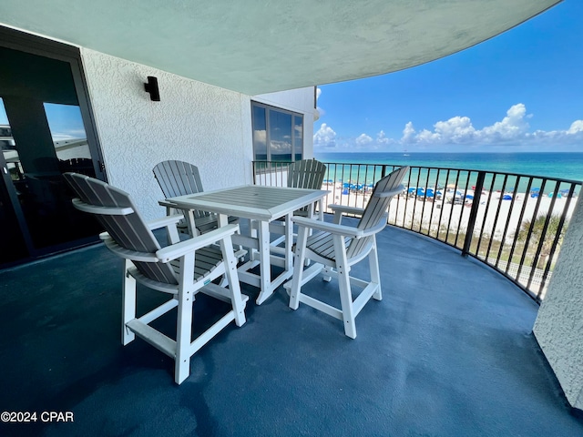 balcony with a view of the beach and a water view