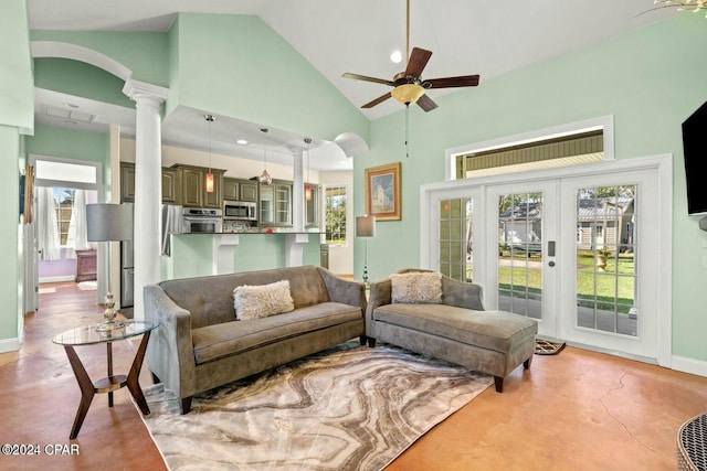 living room with ceiling fan, high vaulted ceiling, a wealth of natural light, and ornate columns