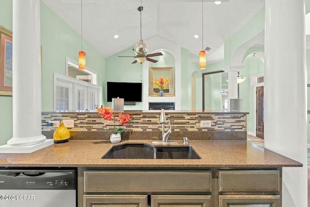 kitchen featuring lofted ceiling, sink, stainless steel dishwasher, decorative backsplash, and ornate columns