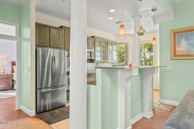 kitchen featuring stone counters, decorative light fixtures, decorative backsplash, a breakfast bar, and appliances with stainless steel finishes