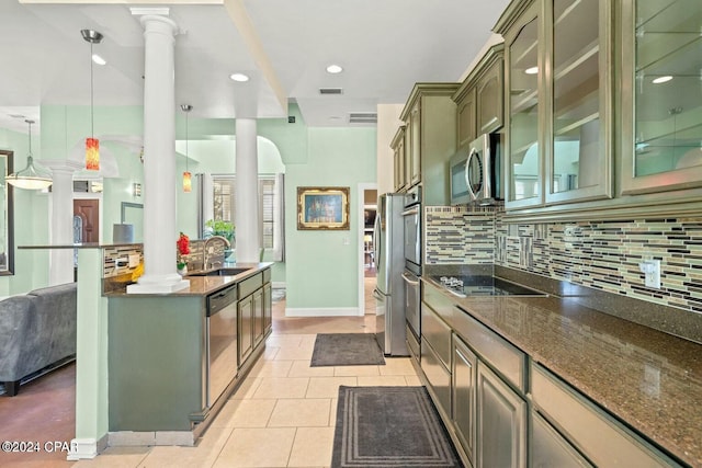 kitchen with sink, hanging light fixtures, decorative backsplash, stainless steel appliances, and decorative columns