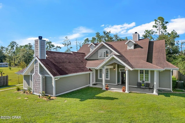 exterior space with central AC and a yard