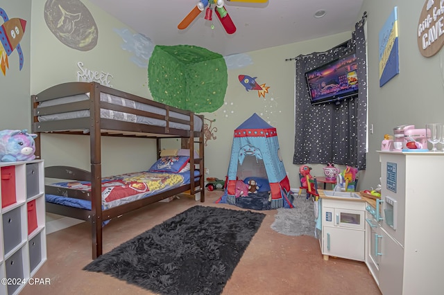 bedroom featuring ceiling fan and concrete floors