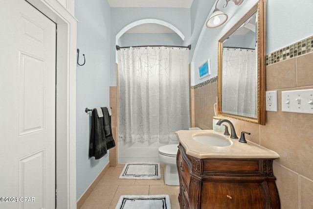 bathroom with tile patterned floors, vanity, and tile walls