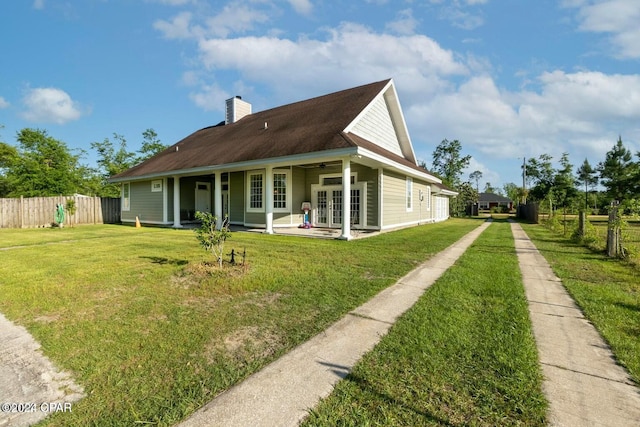 exterior space with a yard and french doors