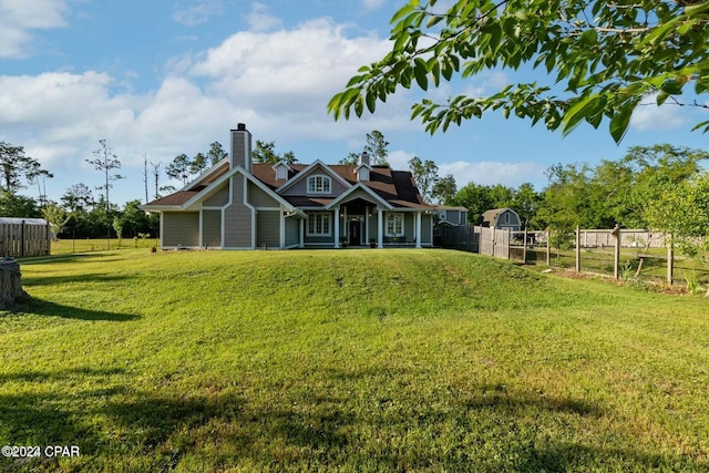 back of property with a lawn