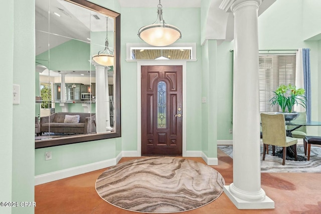 foyer with ornate columns and high vaulted ceiling