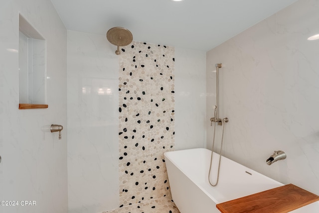 bathroom featuring a tile shower and tile walls