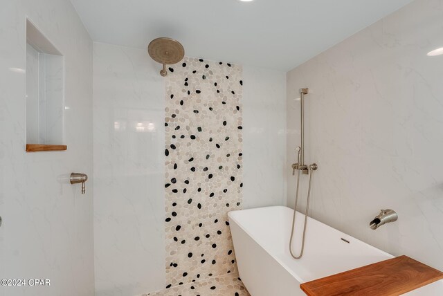 8715 Surf Dr Unit 201A, Panama City Beach, FL 32408 - bathroom with a shower, a freestanding tub, and tile walls