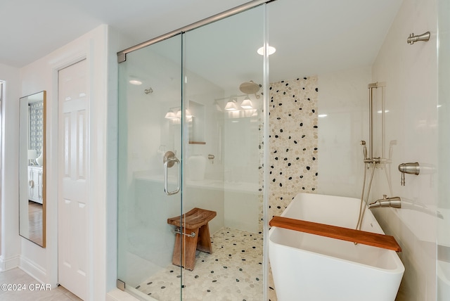 bathroom with tile patterned floors and shower with separate bathtub