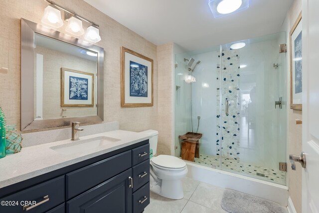 8715 Surf Dr Unit 201A, Panama City Beach, FL 32408 - bathroom with toilet, a stall shower, tile patterned flooring, and vanity