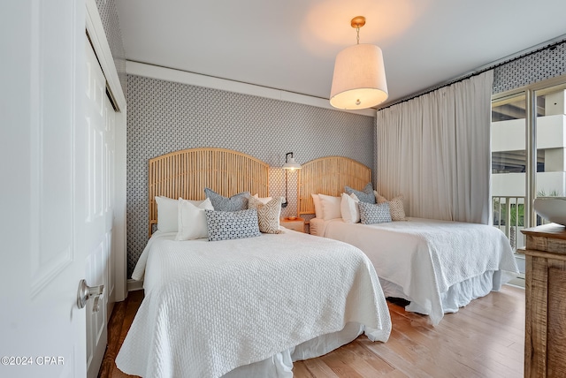 bedroom with light wood-type flooring and a closet