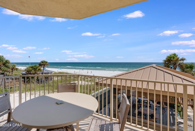 balcony with a beach view and a water view