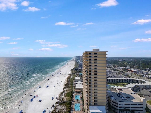 drone / aerial view featuring a beach view and a water view