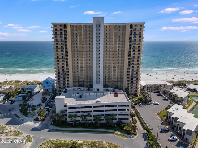 birds eye view of property with a water view and a view of the beach