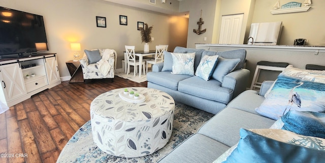 living area featuring dark wood-style floors and baseboards