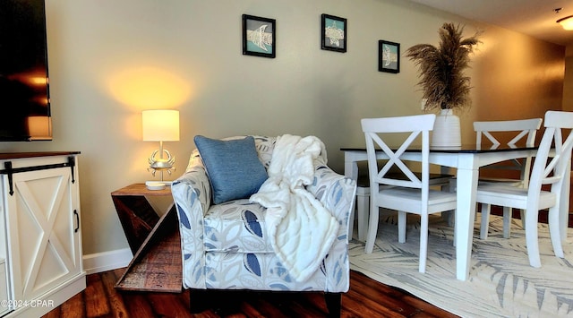 sitting room featuring baseboards and dark wood finished floors