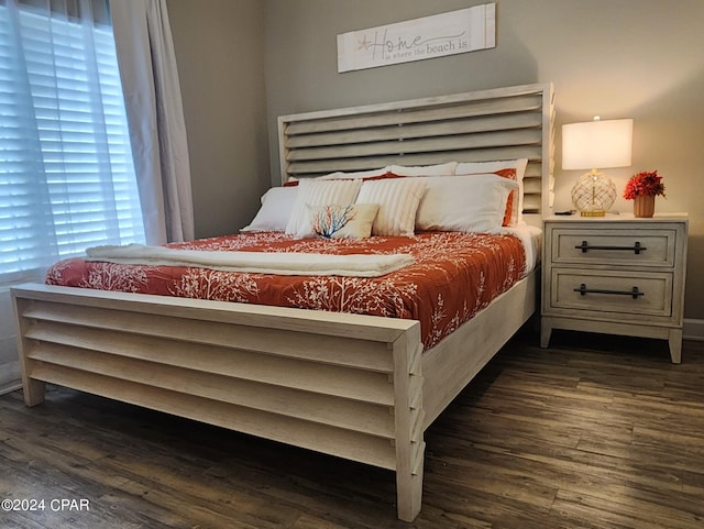 bedroom with dark wood-style floors