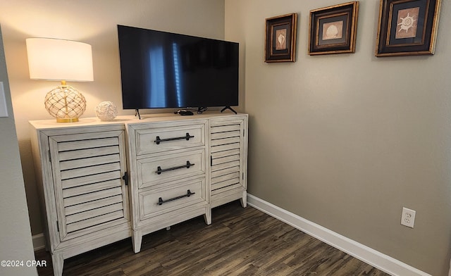 room details with baseboards and wood finished floors