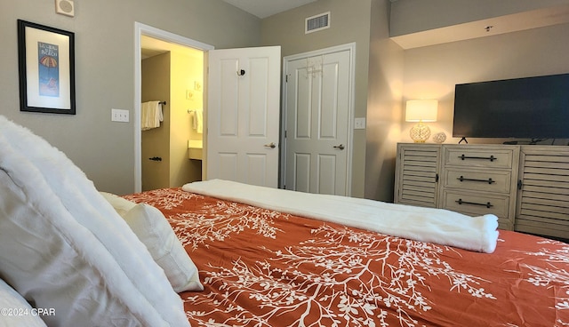 bedroom with visible vents and ensuite bathroom