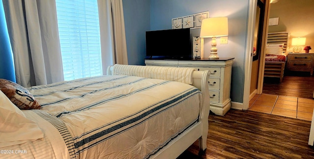 bedroom featuring dark wood-style flooring