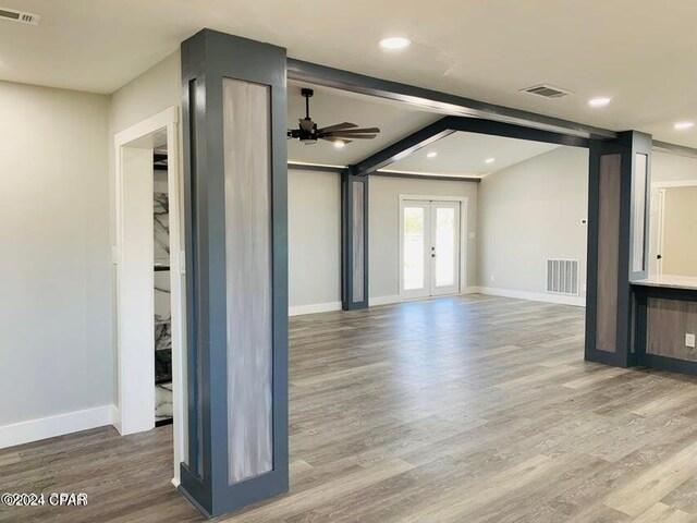 kitchen with french doors, stainless steel appliances, white cabinets, light hardwood / wood-style flooring, and decorative backsplash