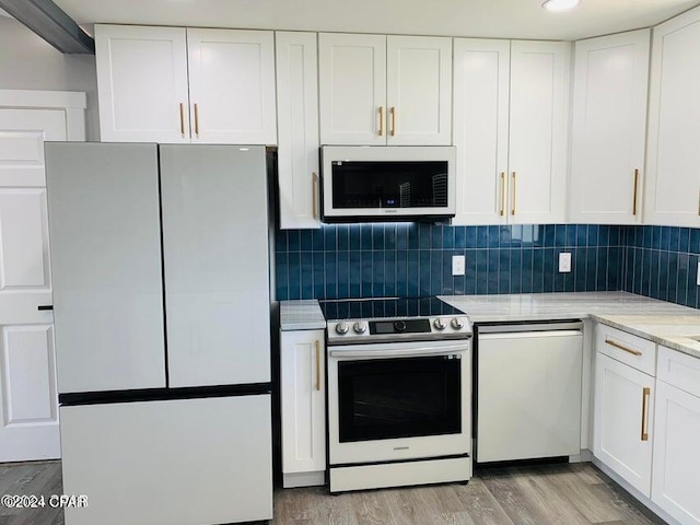 kitchen with white cabinetry, white appliances, tasteful backsplash, and light hardwood / wood-style floors