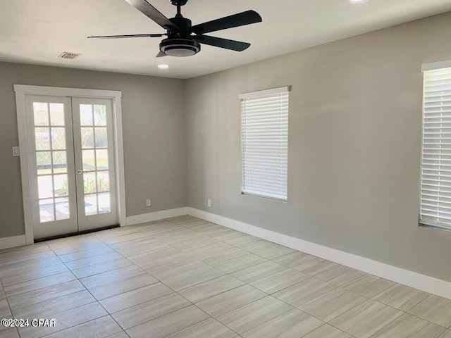 empty room with french doors and ceiling fan