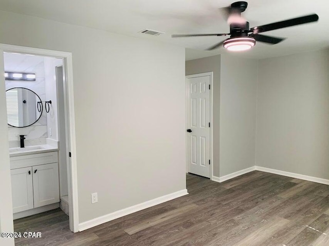 interior space featuring dark wood-type flooring, sink, and ceiling fan