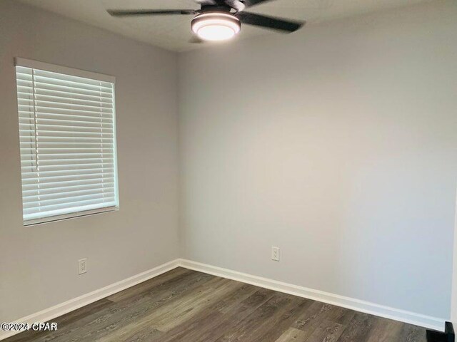 spare room with hardwood / wood-style floors and ceiling fan