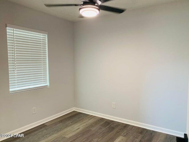 empty room featuring ceiling fan and dark hardwood / wood-style floors