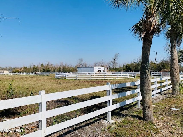 view of yard with a rural view