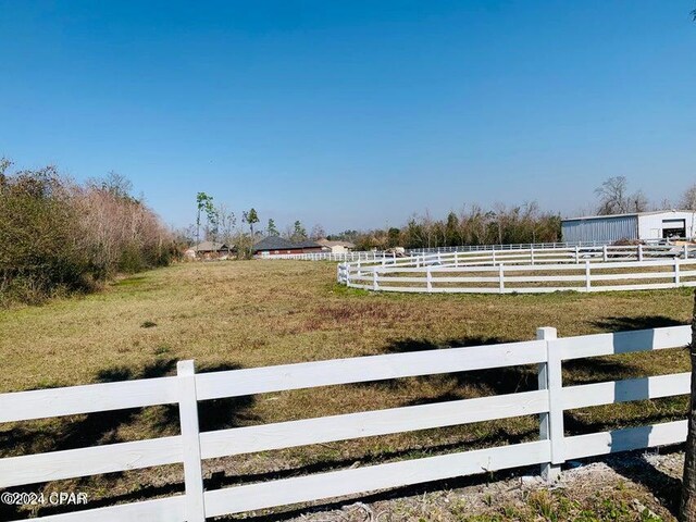 view of yard with a rural view