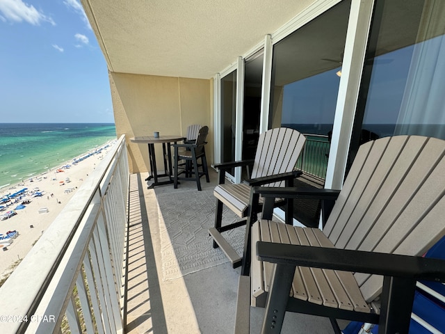 balcony with a water view and a beach view