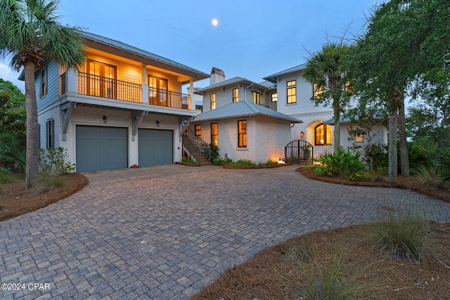 view of front of home with a garage and a balcony