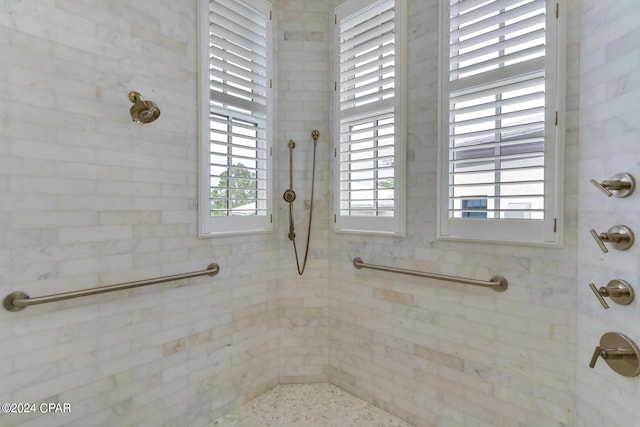 bathroom with tiled shower