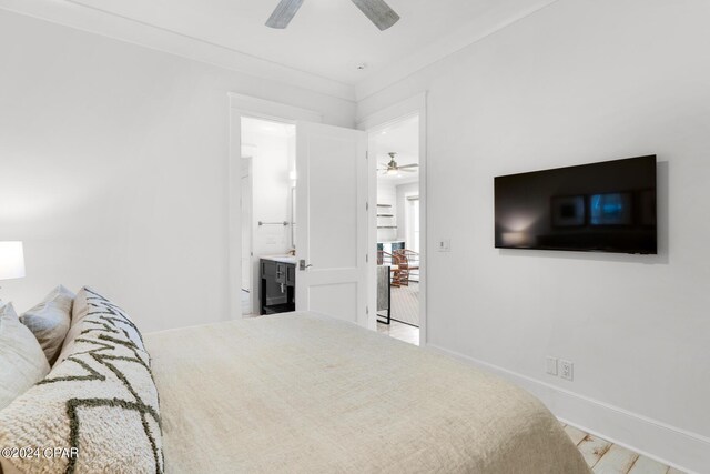 bedroom with ensuite bathroom, ceiling fan, and crown molding