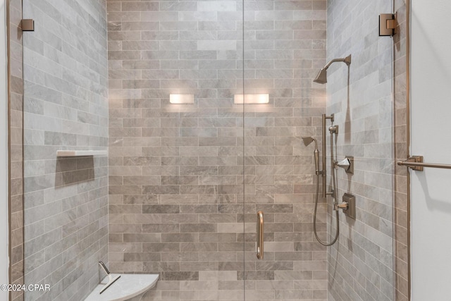 bathroom featuring a shower with door