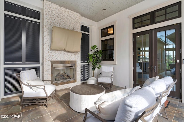 view of patio with a fireplace and french doors