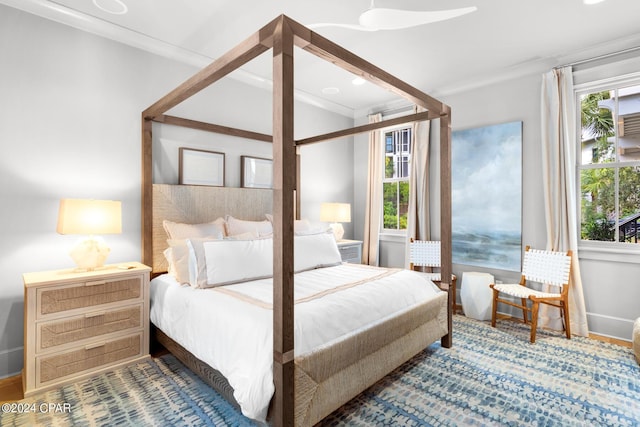 bedroom featuring multiple windows and crown molding