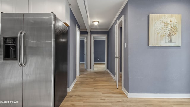 corridor with light wood-type flooring and ornamental molding