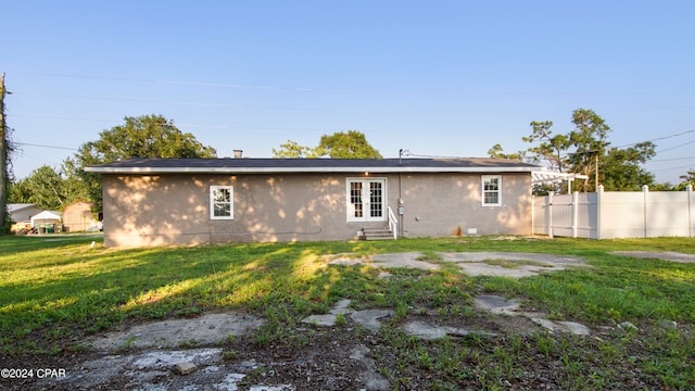 rear view of house with a lawn