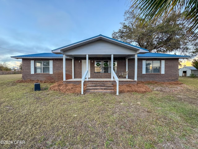 view of front of home with covered porch and a front yard