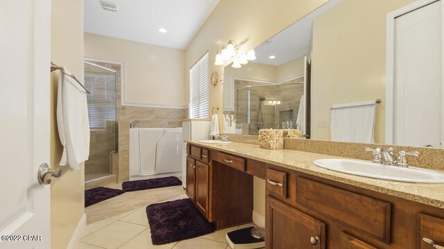 bathroom with tile patterned flooring, an enclosed shower, and double sink vanity