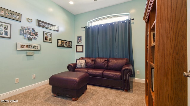 sitting room featuring light colored carpet