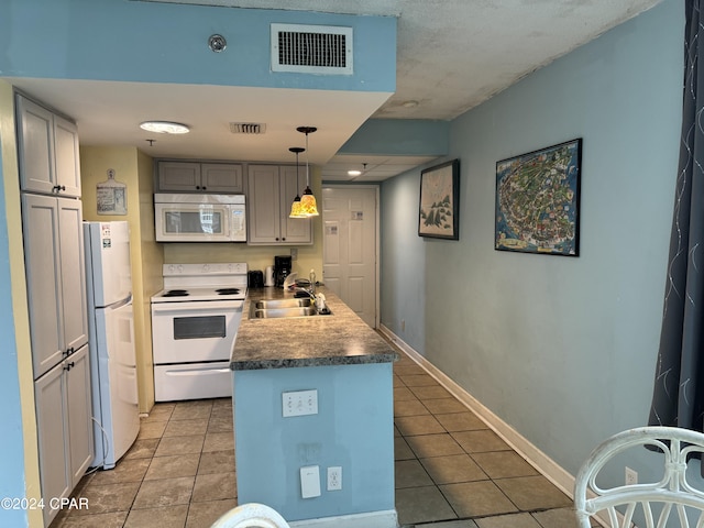 kitchen with tile patterned floors, gray cabinetry, sink, decorative light fixtures, and white appliances