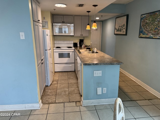 kitchen featuring sink, white appliances, gray cabinetry, light tile patterned floors, and pendant lighting