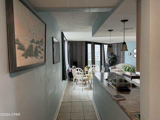 hallway with light tile patterned flooring and sink