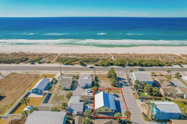 drone / aerial view with a water view and a view of the beach